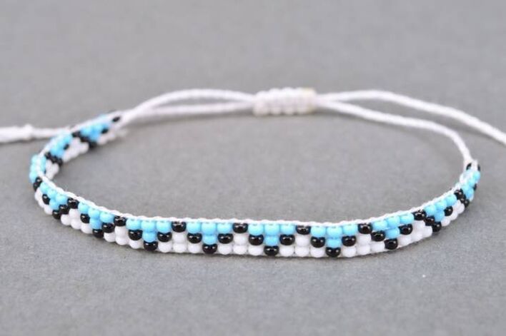 A bracelet made of strings and beads is a talisman that will bring good luck to the owner