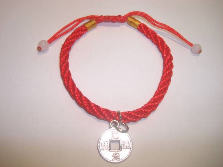A red thread bracelet with a rare coin to attract success